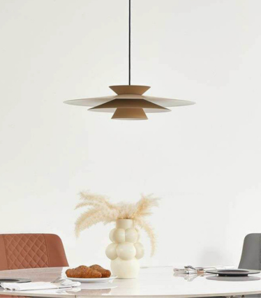 Modern pendant light above dining table with warm natural tones and timeless design.