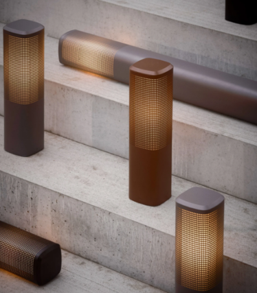 Nordlux outdoor lights with perforated shades in brown and rust tones on concrete steps