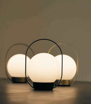 Three cordless Antidark Palla lights with opal glass and metal handles